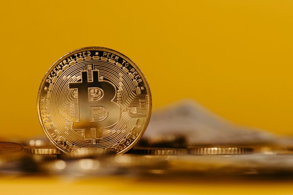 Bitcoin cryptocurrency on yellow background